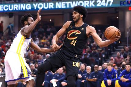 Nov 5, 2023; Cleveland, Ohio, USA; Cleveland Cavaliers center Jarett Allen (31) saves the ball from going out of bounds while defended by Golden State Warriors forward Andrew Wiggins (22) in the first quarter at Rocket Mortgage FieldHouse. Mandatory Credit: Aaron Josefczyk-USA TODAY Sports