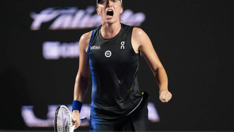 Nov 5, 2023; Cancun, Mexico; Iga Swiatek (POL) celebrates winning her match against Aryna Sabalenka (BLR) on day eight of the GNP Saguaros WTA Finals Cancun. Mandatory Credit: Susan Mullane-USA TODAY Sports