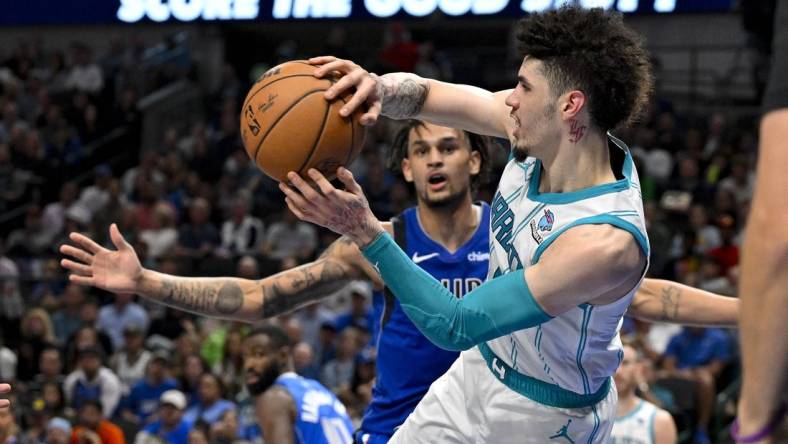 Nov 5, 2023; Dallas, Texas, USA; Charlotte Hornets guard LaMelo Ball (1) passes the ball past Dallas Mavericks center Dereck Lively II (2) during the second half at the American Airlines Center. Mandatory Credit: Jerome Miron-USA TODAY Sports