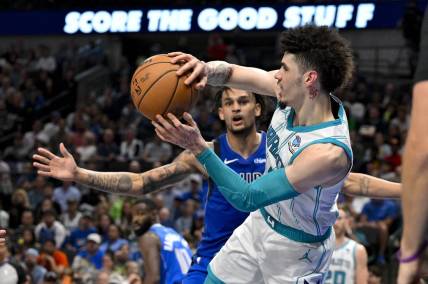 Nov 5, 2023; Dallas, Texas, USA; Charlotte Hornets guard LaMelo Ball (1) passes the ball past Dallas Mavericks center Dereck Lively II (2) during the second half at the American Airlines Center. Mandatory Credit: Jerome Miron-USA TODAY Sports