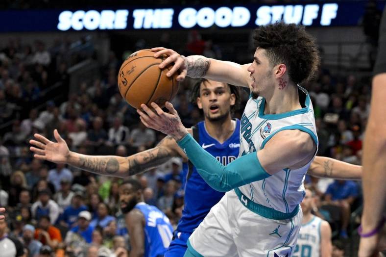 Nov 5, 2023; Dallas, Texas, USA; Charlotte Hornets guard LaMelo Ball (1) passes the ball past Dallas Mavericks center Dereck Lively II (2) during the second half at the American Airlines Center. Mandatory Credit: Jerome Miron-USA TODAY Sports