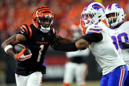 Cincinnati Bengals wide receiver Ja'Marr Chase (1) stiff arms Buffalo Bills cornerback Taron Johnson (7) after a catch in the fourth quarter during a Week 9 NFL football game between the Buffalo Bills and the Cincinnati Bengals, Sunday, Nov. 5, 2023, at Paycor Stadium in Cincinnati.