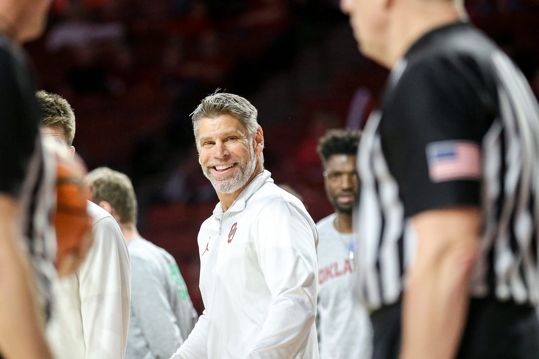 Oklahoma head coach Porter Moser smiles at referees in the second half during a basketball game between The Oklahoma Sooners (OU) and Kansas State Wildcats at the Lloyd Noble Center in Norman, Okla., Tuesday, Feb. 14, 2023.