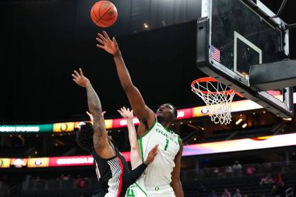 Nov 6, 2023; Las Vegas, Nevada, USA; Oregon Ducks center N'Faly Dante (1) defends against a shot by Georgia Bulldogs guard Justin Hill (11) during the second half at T-Mobile Arena. Mandatory Credit: Stephen R. Sylvanie-USA TODAY Sports