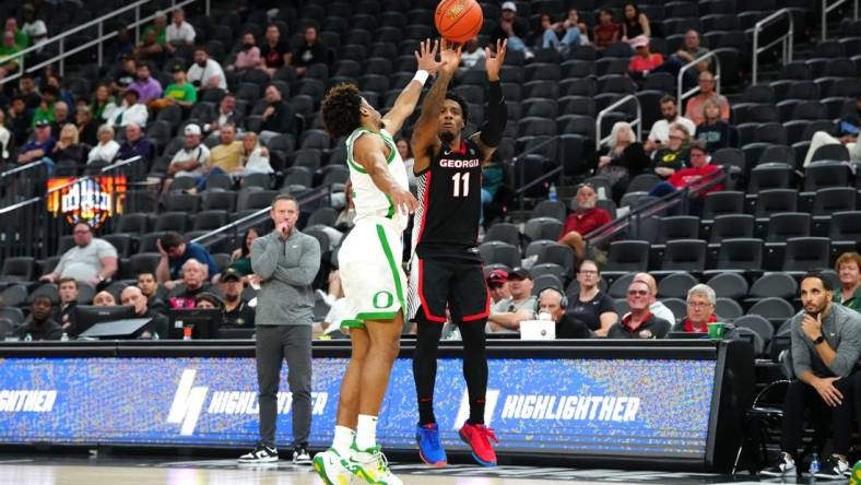 Nov 6, 2023; Las Vegas, Nevada, USA; Georgia Bulldogs guard Justin Hill (11) shoots against Oregon Ducks guard Jadrian Tracey (22) during the second half at T-Mobile Arena. Mandatory Credit: Stephen R. Sylvanie-USA TODAY Sports