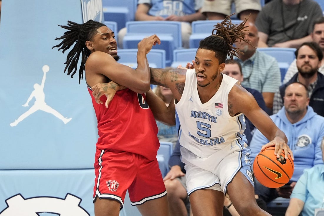 Nov 6, 2023; Chapel Hill, North Carolina, USA;  North Carolina Tar Heels forward Armando Bacot (5) with the ball as Radford Highlanders forward Justin Archer (0) defends in the first half at Dean E. Smith Center. Mandatory Credit: Bob Donnan-USA TODAY Sports