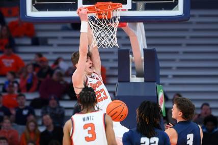 Nov 6, 2023; Syracuse, New York, USA; Syracuse Orange center Peter Carey (23) reacts to his dunk against the New Hampshire Wildcats during the first half at the JMA Wireless Dome. Mandatory Credit: Rich Barnes-USA TODAY Sports