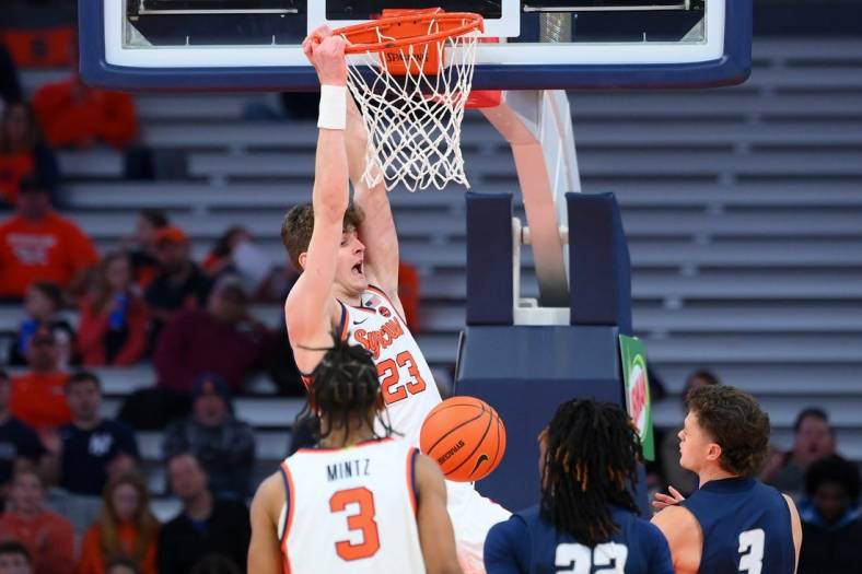 Nov 6, 2023; Syracuse, New York, USA; Syracuse Orange center Peter Carey (23) reacts to his dunk against the New Hampshire Wildcats during the first half at the JMA Wireless Dome. Mandatory Credit: Rich Barnes-USA TODAY Sports