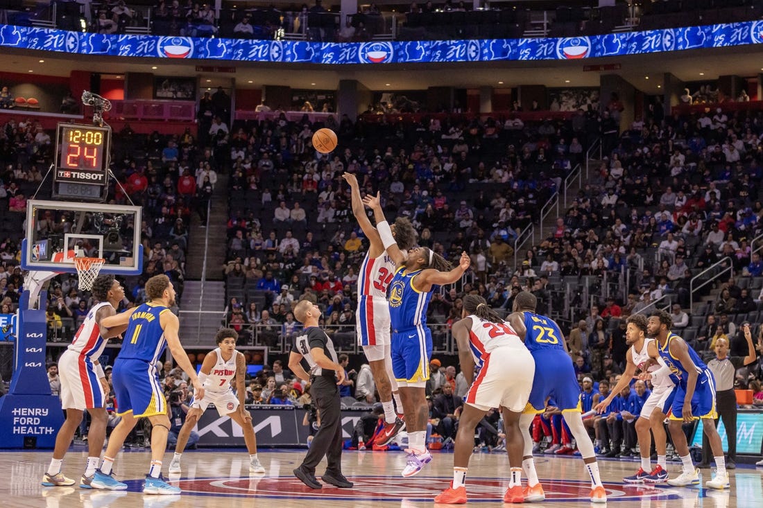 Nov 6, 2023; Detroit, Michigan, USA; Detroit Pistons forward Marvin Bagley III (35) and Golden State Warriors forward Kevon Looney (5) jump for the basketball to start the game at Little Caesars Arena. Mandatory Credit: David Reginek-USA TODAY Sports