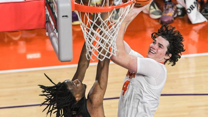 Clemson junior forward Ian Schieffelin (4) scores near Winthrop forward Chase Clayton (33) during the first half at Littlejohn Coliseum in Clemson, S.C. Monday, November 6, 2023.