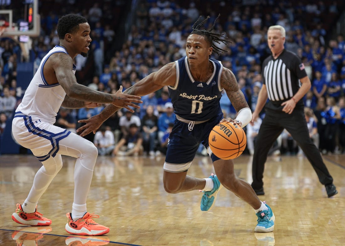 Nov 6, 2023; Newark, New Jersey, USA; St. Peter's Peacocks guard Latrell Reid (0) dribbles against Seton Hall Pirates guard Al-Amir Dawes (2) during the first half at Prudential Center. Mandatory Credit: Vincent Carchietta-USA TODAY Sports