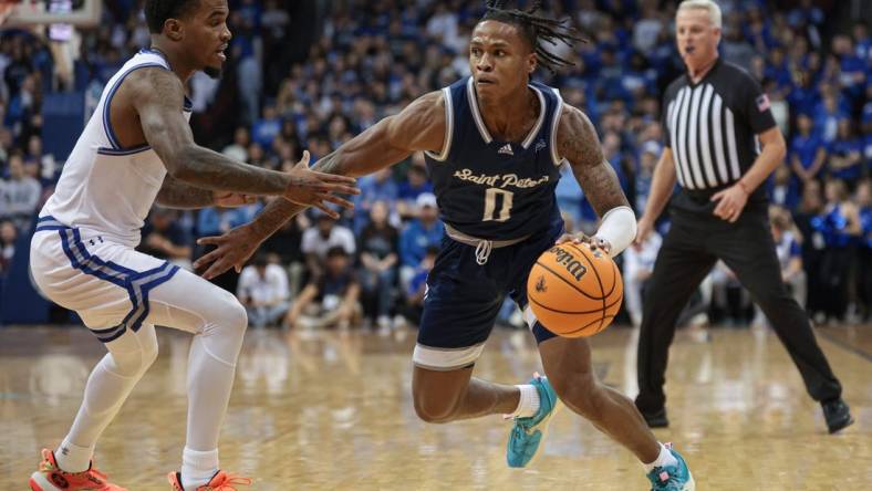 Nov 6, 2023; Newark, New Jersey, USA; St. Peter's Peacocks guard Latrell Reid (0) dribbles against Seton Hall Pirates guard Al-Amir Dawes (2) during the first half at Prudential Center. Mandatory Credit: Vincent Carchietta-USA TODAY Sports