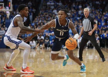 Nov 6, 2023; Newark, New Jersey, USA; St. Peter's Peacocks guard Latrell Reid (0) dribbles against Seton Hall Pirates guard Al-Amir Dawes (2) during the first half at Prudential Center. Mandatory Credit: Vincent Carchietta-USA TODAY Sports