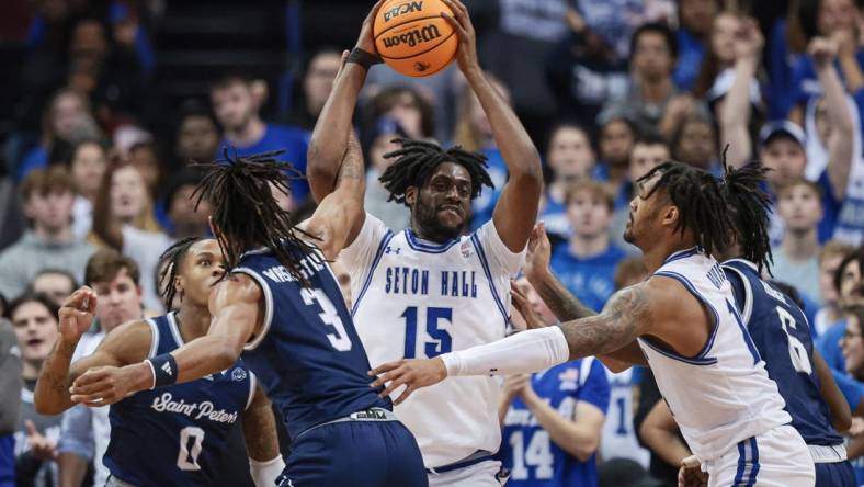 Nov 6, 2023; Newark, New Jersey, USA; Seton Hall Pirates center Jaden Bediako (15) rebounds against St. Peter's Peacocks forward Corey Washington (3) during the first half at Prudential Center. Mandatory Credit: Vincent Carchietta-USA TODAY Sports