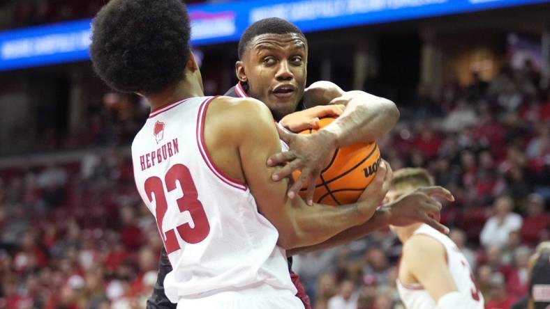 Nov 6, 2023; Madison, Wisconsin, USA;  Wisconsin Badgers guard Chucky Hepburn (23) forces a jump ball with Arkansas State Red Wolves guard Derrian Ford (3) during the first half at the Kohl Center. Mandatory Credit: Kayla Wolf-USA TODAY Sports