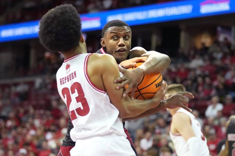 Nov 6, 2023; Madison, Wisconsin, USA;  Wisconsin Badgers guard Chucky Hepburn (23) forces a jump ball with Arkansas State Red Wolves guard Derrian Ford (3) during the first half at the Kohl Center. Mandatory Credit: Kayla Wolf-USA TODAY Sports