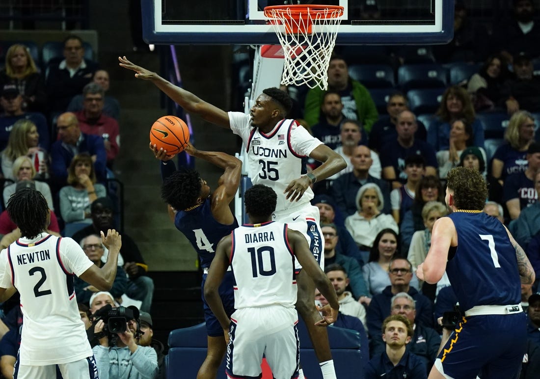 Nov 6, 2023; Storrs, Connecticut, USA; UConn Huskies forward Samson Johnson (35) defends against Northern Arizona Lumberjacks guard Oakland Fort (4) in the first half at Harry A. Gampel Pavilion. Mandatory Credit: David Butler II-USA TODAY Sports