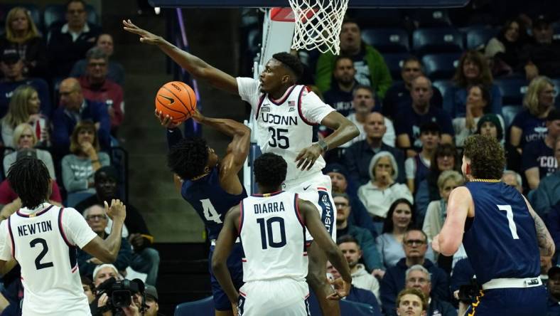 Nov 6, 2023; Storrs, Connecticut, USA; UConn Huskies forward Samson Johnson (35) defends against Northern Arizona Lumberjacks guard Oakland Fort (4) in the first half at Harry A. Gampel Pavilion. Mandatory Credit: David Butler II-USA TODAY Sports