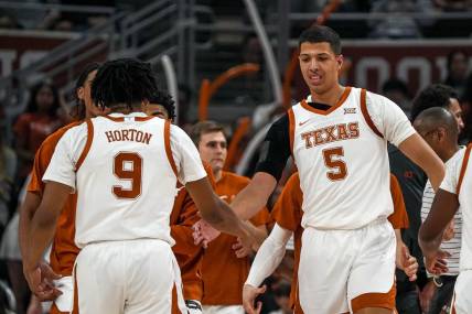 Texas Longhorns forward Kadin Shedrick (5) celebrates with guard Ithiel Horton (9) during a timeout in the men   s basketball game against the University of the Incarnate Word at the Moody Center on Monday, Nov. 6, 2023 in Austin.