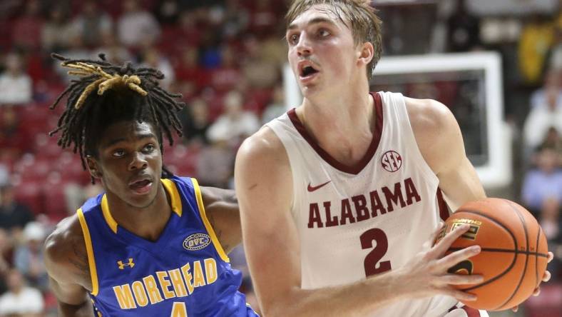 Nov 6, 2023; Tuscaloosa, Alabama, USA; Alabama forward Grant Nelson (2) drives past Morehead State guard Eddie Ricks (4) on his way to the hoop in the game at Coleman Coliseum. Mandatory Credit: Gary Cosby Jr.-USA TODAY Sports