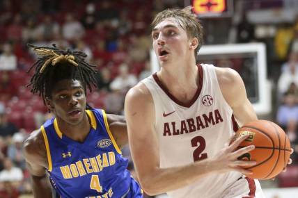 Nov 6, 2023; Tuscaloosa, Alabama, USA; Alabama forward Grant Nelson (2) drives past Morehead State guard Eddie Ricks (4) on his way to the hoop in the game at Coleman Coliseum. Mandatory Credit: Gary Cosby Jr.-USA TODAY Sports
