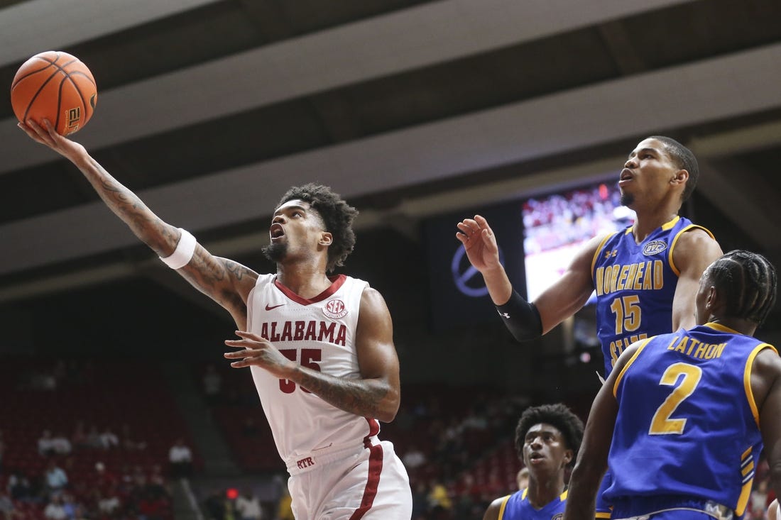 Nov 6, 2023; Tuscaloosa, Alabama, USA;  Alabama guard Aaron Estrada drives and scores past Morehead State guard Kalil Thomas (15) and Morehead State guard Jordan Lathon (2) in the game at Coleman Coliseum. Mandatory Credit: Gary Cosby Jr.-USA TODAY Sports