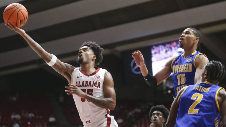 Nov 6, 2023; Tuscaloosa, Alabama, USA;  Alabama guard Aaron Estrada drives and scores past Morehead State guard Kalil Thomas (15) and Morehead State guard Jordan Lathon (2) in the game at Coleman Coliseum. Mandatory Credit: Gary Cosby Jr.-USA TODAY Sports