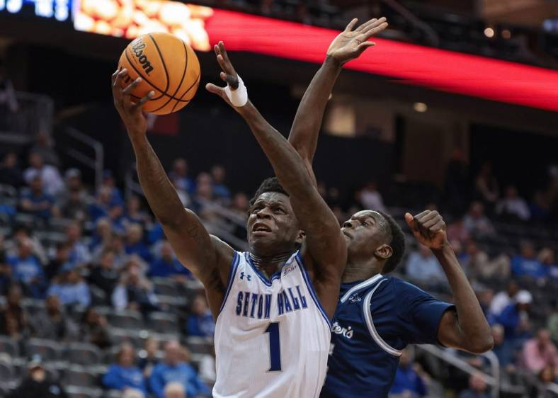 Nov 6, 2023; Newark, New Jersey, USA; Seton Hall Pirates guard Kadary Richmond (1) drives to the basket as St. Peter's Peacocks forward Mouhamed Sow (35) defends during the second half at Prudential Center. Mandatory Credit: Vincent Carchietta-USA TODAY Sports