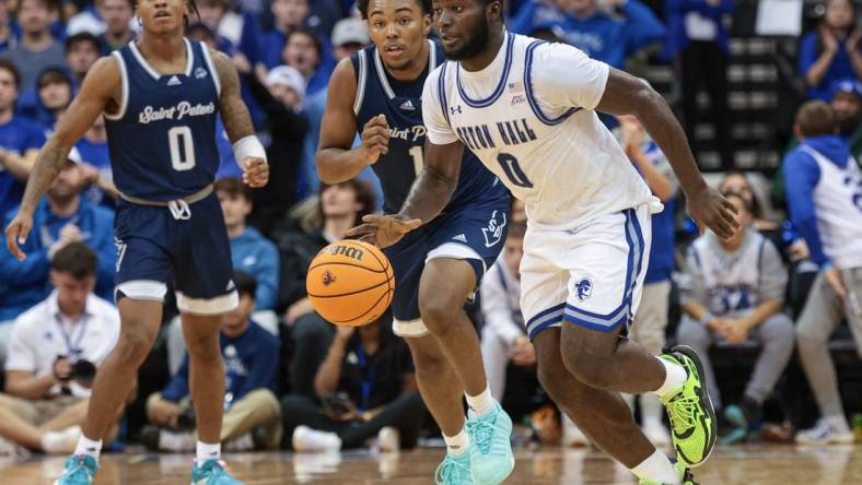 Nov 6, 2023; Newark, New Jersey, USA; Seton Hall Pirates guard Dylan Addae-Wusu (0) dribbles in front of St. Peter's Peacocks guard Brent Bland (1) and guard Latrell Reid (0) during the second half at Prudential Center. Mandatory Credit: Vincent Carchietta-USA TODAY Sports