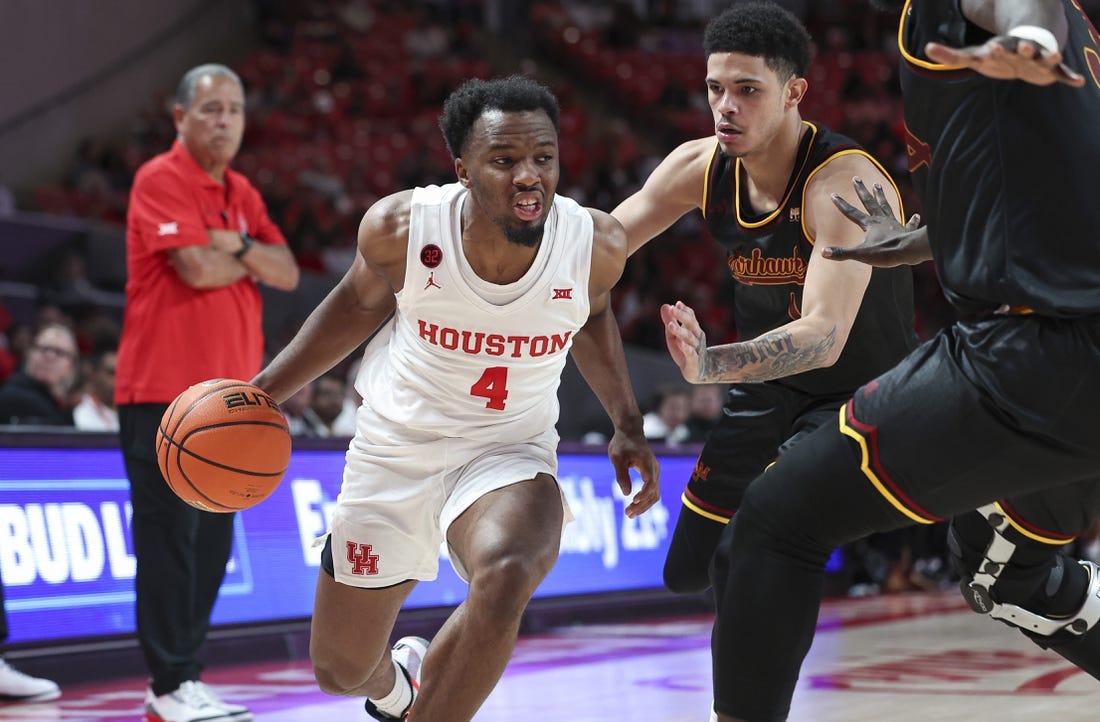 Nov 6, 2023; Houston, Texas, USA; Houston Cougars guard LJ Cryer (4) drives with the ball as Louisiana Monroe Warhawks guard Savion Gallion (1) defends during the second half at Fertitta Center. Mandatory Credit: Troy Taormina-USA TODAY Sports