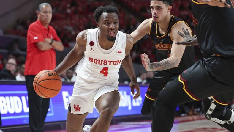 Nov 6, 2023; Houston, Texas, USA; Houston Cougars guard LJ Cryer (4) drives with the ball as Louisiana Monroe Warhawks guard Savion Gallion (1) defends during the second half at Fertitta Center. Mandatory Credit: Troy Taormina-USA TODAY Sports