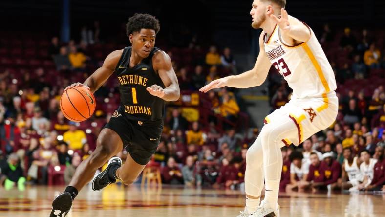 Nov 6, 2023; Minneapolis, Minnesota, USA; Bethune-Cookman Wildcats guard Zion Harmon (1) dribbles around Minnesota Golden Gophers forward Parker Fox (23) during the second half at Williams Arena. Mandatory Credit: Matt Krohn-USA TODAY Sports