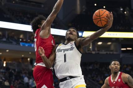 Nov 6, 2023; Milwaukee, Wisconsin, USA;  Marquette Golden Eagles guard Kam Jones (1) shoots against Northern Illinois Huskies guard Zion Russell (10) during the second half at Fiserv Forum. Mandatory Credit: Jeff Hanisch-USA TODAY Sports