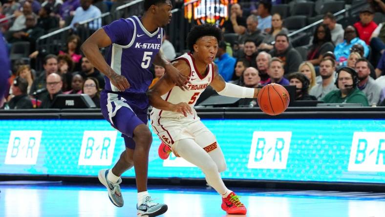 Nov 6, 2023; Las Vegas, Nevada, USA; USC Trojans guard Boogie Ellis (5) dribbles against Kansas State Wildcats guard Cam Carter (5) during the first half at T-Mobile Arena. Mandatory Credit: Stephen R. Sylvanie-USA TODAY Sports