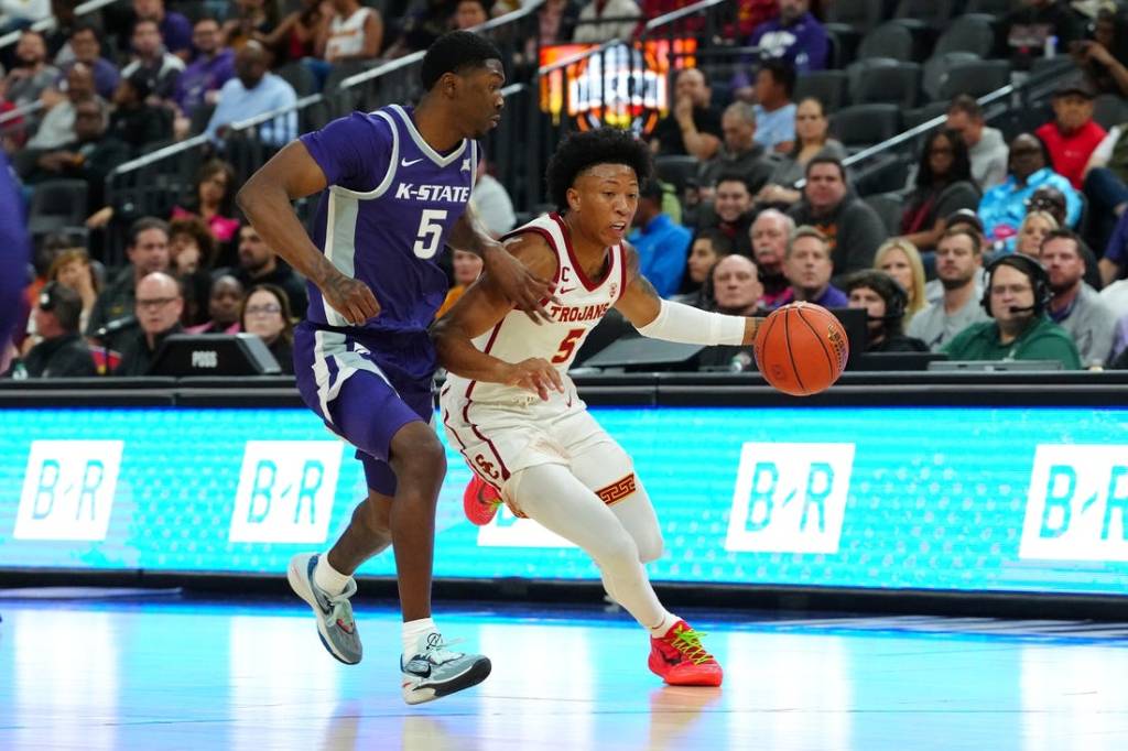 Nov 6, 2023; Las Vegas, Nevada, USA; USC Trojans guard Boogie Ellis (5) dribbles against Kansas State Wildcats guard Cam Carter (5) during the first half at T-Mobile Arena. Mandatory Credit: Stephen R. Sylvanie-USA TODAY Sports