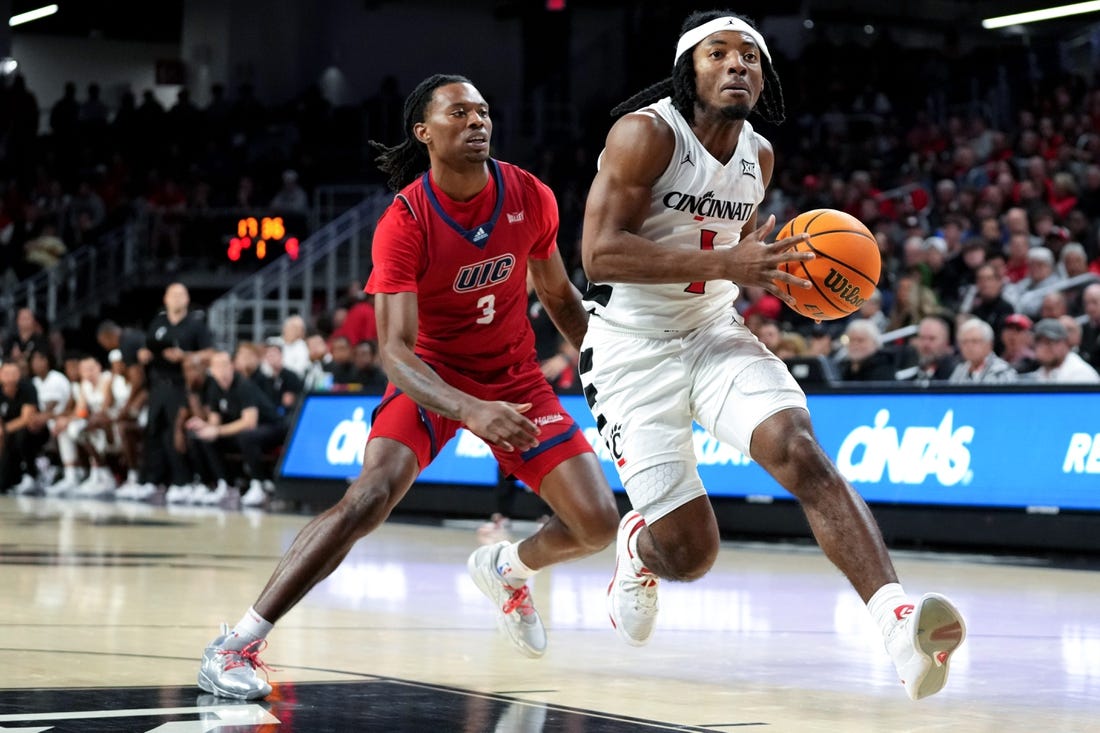 Cincinnati Bearcats guard Day Day Thomas (1) drives to the basket as Illinois-Chicago Flames guard CJ Jones (3) defends in the first half of a men   s college basketball game between the Illinois-Chicago Flames and the Cincinnati Bearcats, Monday, Nov. 6, 2023, at Fifth Third Arena in Cincinnati.