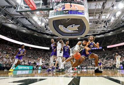 Nov 6, 2023; East Lansing, Michigan, USA; Michigan State Spartans guard Jaden Akins (3) battles with James Madison Dukes forward T.J. Bickerstaff (3) for a loose ball at Jack Breslin Student Events Center. Mandatory Credit: Dale Young-USA TODAY Sports