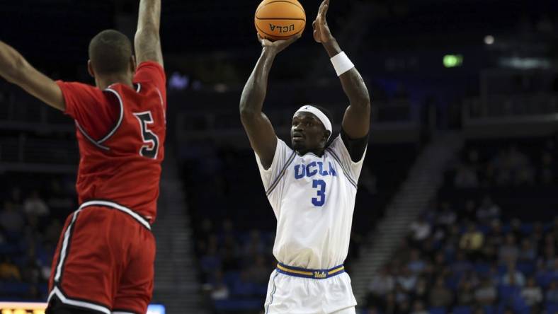 Nov 6, 2023; Los Angeles, California, USA;  UCLA Bruins forward Adem Bona (3) shoots against St. Francis (Pa) Red Flash forward Eli Wilborn (5) during the first half at Pauley Pavilion presented by Wescom. Mandatory Credit: Kiyoshi Mio-USA TODAY Sports