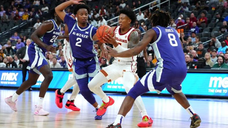 Nov 6, 2023; Las Vegas, Nevada, USA; USC Trojans guard Boogie Ellis (5) passes the ball between Kansas State Wildcats guard Tylor Perry (2) and Kansas State Wildcats guard R.J. Jones (8) during the first half at T-Mobile Arena. Mandatory Credit: Stephen R. Sylvanie-USA TODAY Sports