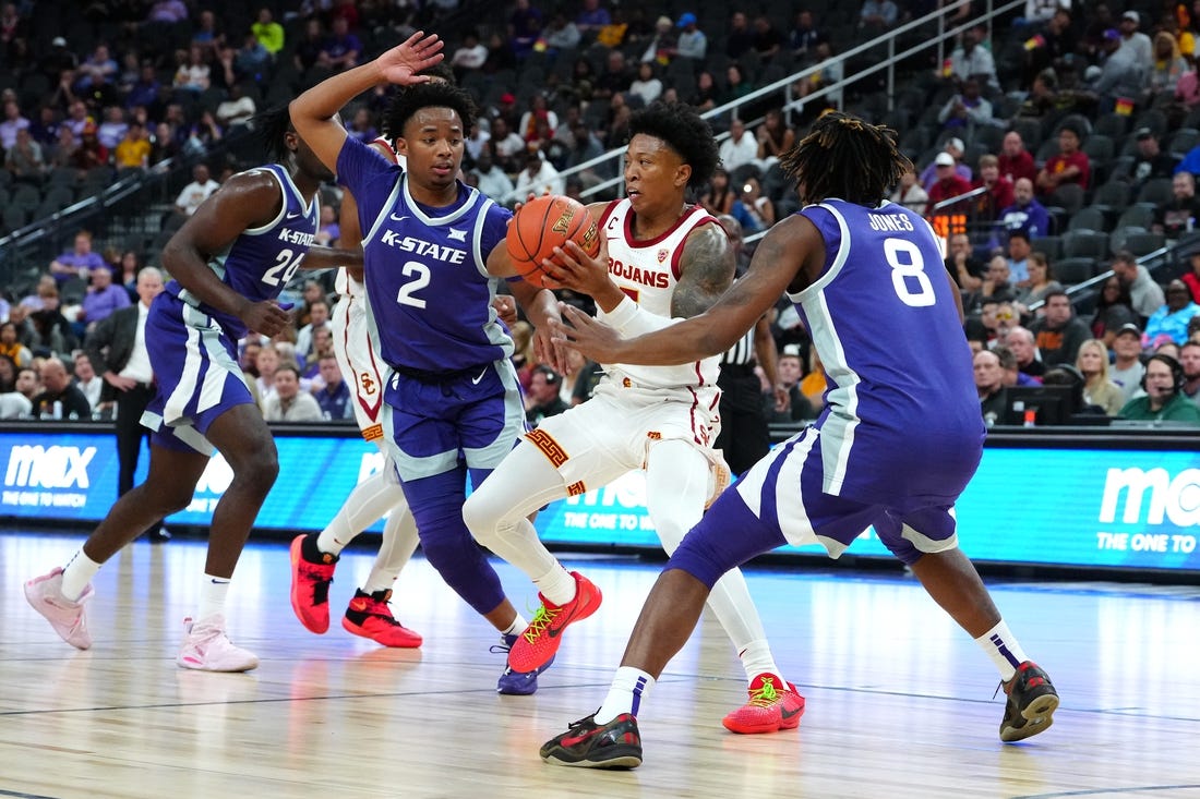 Nov 6, 2023; Las Vegas, Nevada, USA; USC Trojans guard Boogie Ellis (5) passes the ball between Kansas State Wildcats guard Tylor Perry (2) and Kansas State Wildcats guard R.J. Jones (8) during the first half at T-Mobile Arena. Mandatory Credit: Stephen R. Sylvanie-USA TODAY Sports