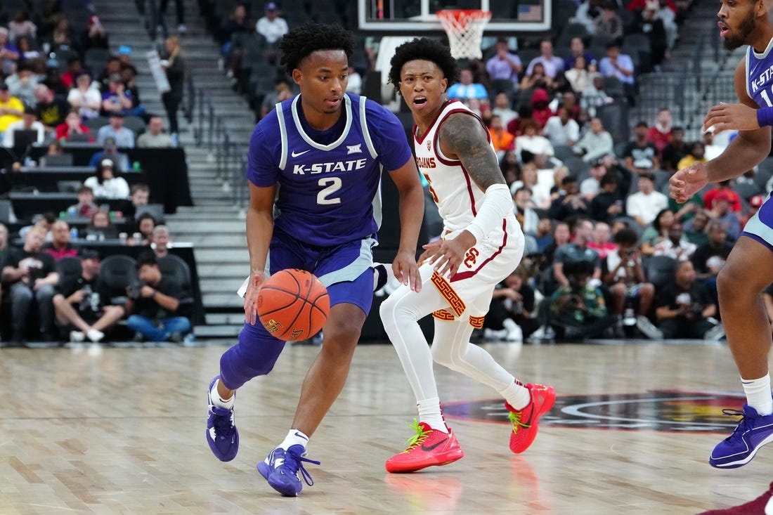 Nov 6, 2023; Las Vegas, Nevada, USA; Kansas State Wildcats guard Tylor Perry (2) dribbles against USC Trojans guard Boogie Ellis (5) during the second half at T-Mobile Arena. Mandatory Credit: Stephen R. Sylvanie-USA TODAY Sports