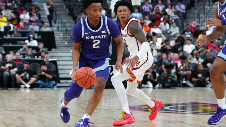 Nov 6, 2023; Las Vegas, Nevada, USA; Kansas State Wildcats guard Tylor Perry (2) dribbles against USC Trojans guard Boogie Ellis (5) during the second half at T-Mobile Arena. Mandatory Credit: Stephen R. Sylvanie-USA TODAY Sports