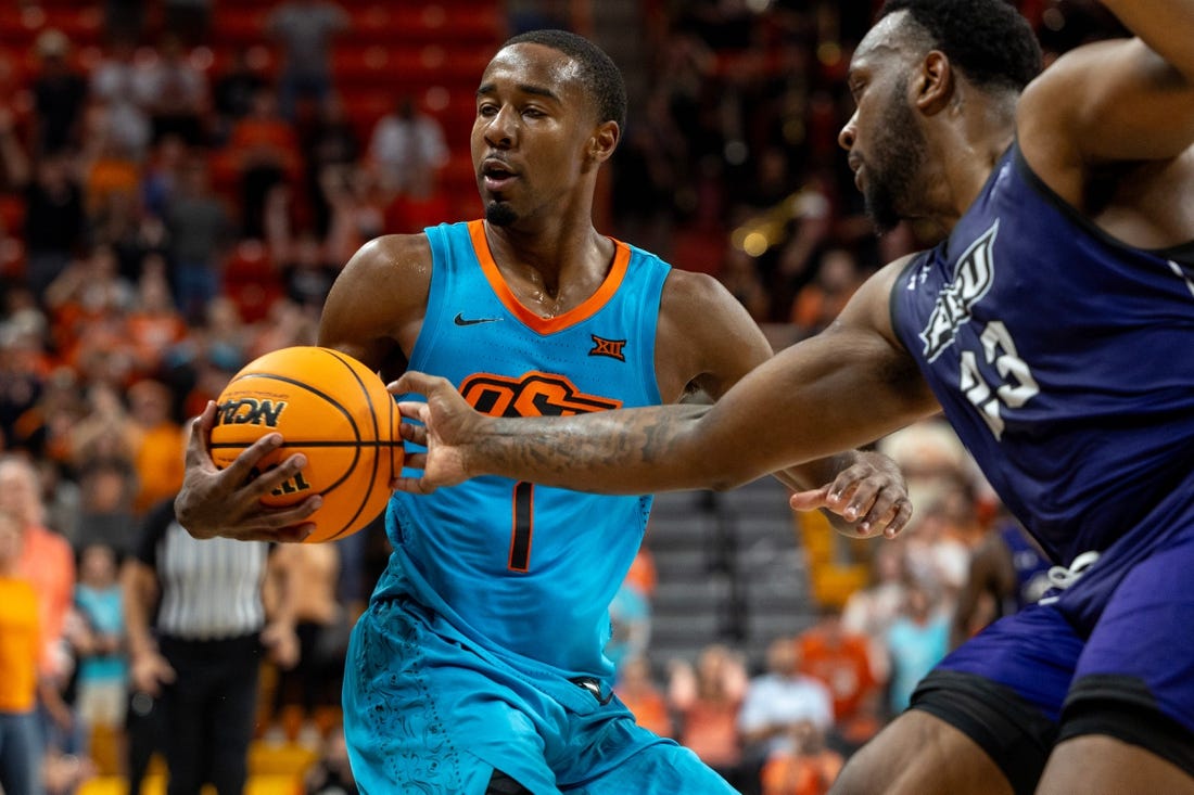 Abilene Christian forward Airion Simmons (23) fouls Oklahoma State guard Bryce Thompson (1) the second half of an NCAA men  s college basketball game Monday, Nov. 6, 2023., in Stillwater, Okla. (Mitch Alcala for the Oklahoman)