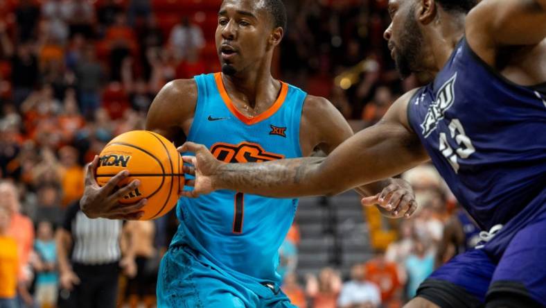 Abilene Christian forward Airion Simmons (23) fouls Oklahoma State guard Bryce Thompson (1) the second half of an NCAA men  s college basketball game Monday, Nov. 6, 2023., in Stillwater, Okla. (Mitch Alcala for the Oklahoman)