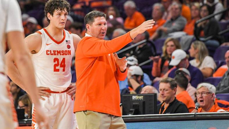 Clemson junior forward PJ Hall (24) listens to Clemson Head Coach Brad Brownell in the game with Winthrop during the second half at Littlejohn Coliseum in Clemson, S.C. Monday, November 6, 2023.