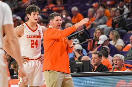 Clemson junior forward PJ Hall (24) listens to Clemson Head Coach Brad Brownell in the game with Winthrop during the second half at Littlejohn Coliseum in Clemson, S.C. Monday, November 6, 2023.
