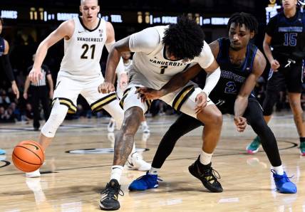 Vanderbilt forward Colin Smith (1) loses control of the ball as Presbyterian guard Samage Teel (2) reaches in during the second half of an NCAA college basketball game Tuesday, Nov. 7, 2023, in Nashville, Tenn. Vanderbilt lost 68-62.