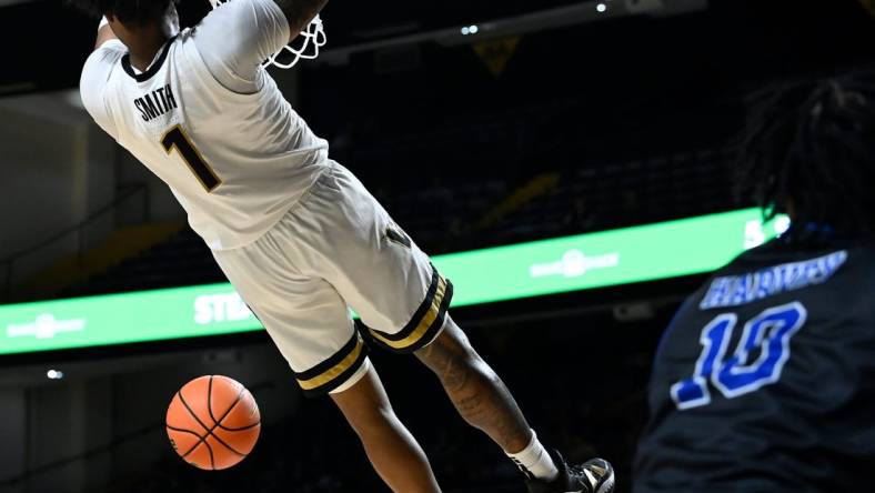 Vanderbilt forward Colin Smith (1) dunks the ball against Presbyterian during the first half of an NCAA college basketball game Tuesday, Nov. 7, 2023, in Nashville, Tenn.