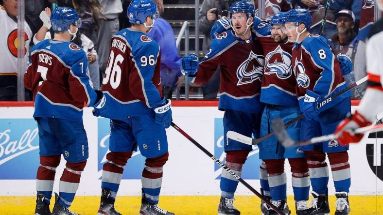 Nov 7, 2023; Denver, Colorado, USA; Colorado Avalanche center Ryan Johansen (12) celebrates his goal with left wing Tomas Tatar (90) and defenseman Cale Makar (8) and right wing Mikko Rantanen (96) and defenseman Devon Toews (7) in the third period against the New Jersey Devils at Ball Arena. Mandatory Credit: Isaiah J. Downing-USA TODAY Sports