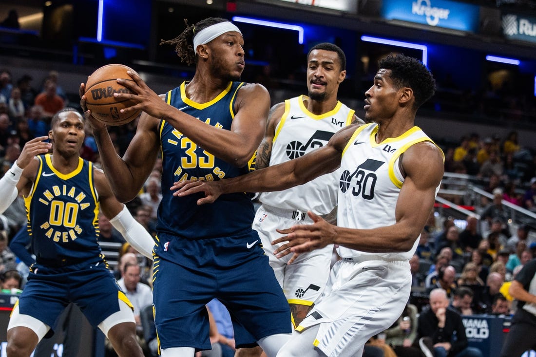 Nov 8, 2023; Indianapolis, Indiana, USA; Indiana Pacers center Myles Turner (33) rebounds the ball while Utah Jazz guard Ochai Agbaji (30) defends in the first quarter at Gainbridge Fieldhouse. Mandatory Credit: Trevor Ruszkowski-USA TODAY Sports